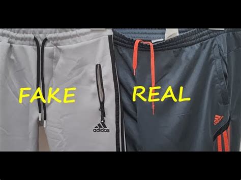 how to spot fake adidas tracksuit|real adidas tracksuit pants.